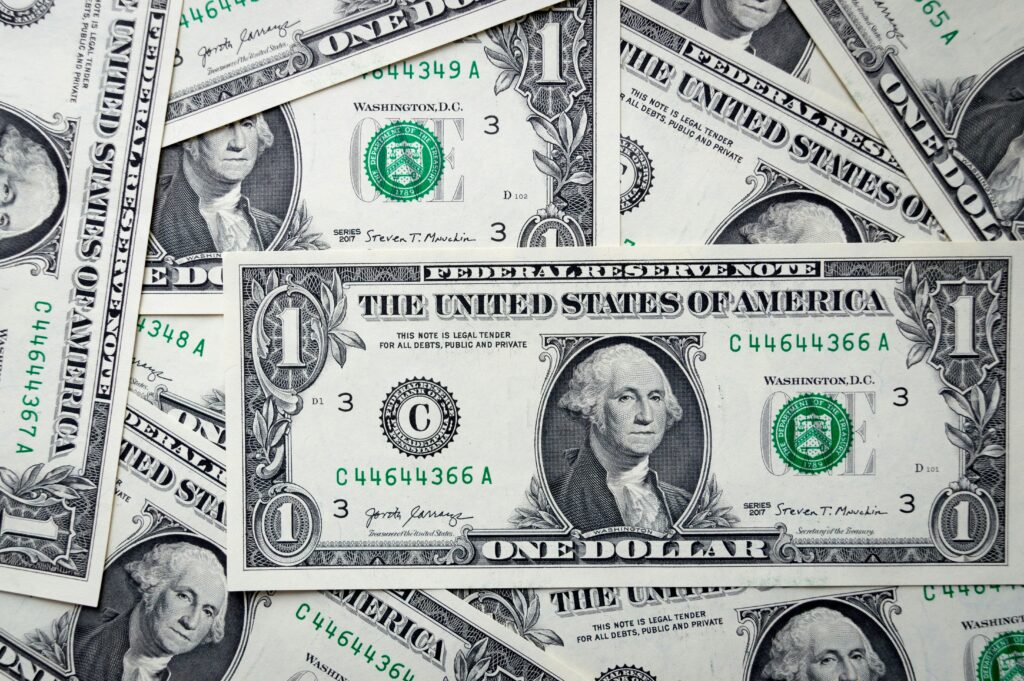 Close-up of U.S. one-dollar bills scattered as a money background.